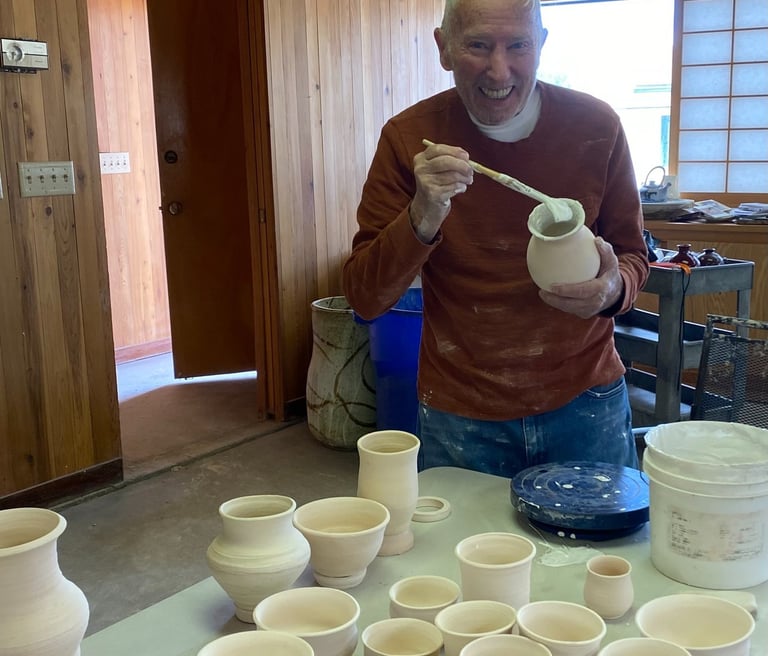 Rich Sim glazing his vase in an art therapy workshop