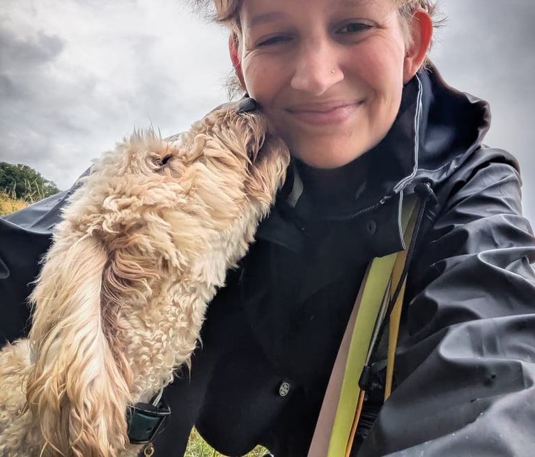 Image of a dog licking a woman's face