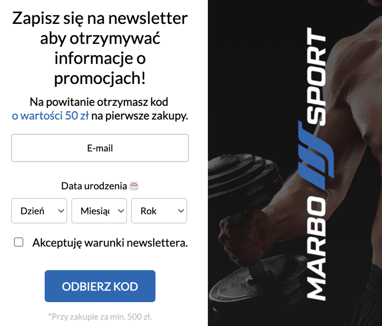 a man holding a dumb dumbble in front of a banner