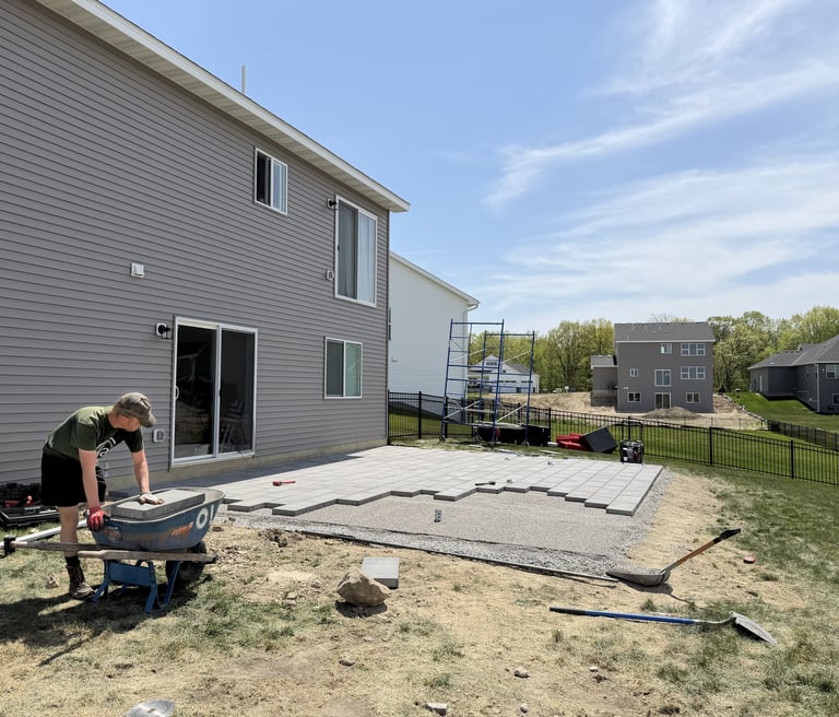 Oja Lawn & Landscape employee building paver patio