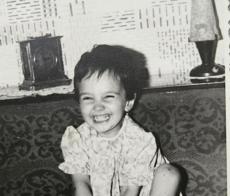 a toddler laughing towards the camera