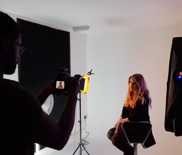 a woman sitting in a chair in a studio
