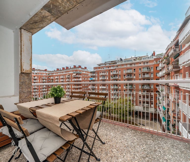 Private balcony with outdoor seating overlooking Plaza del Sauce, San Sebastian