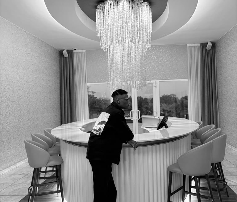 reed standing in front of a bar with a chandelier