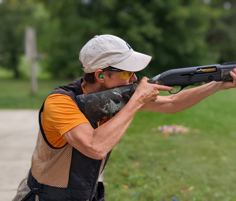 Woman with 20ga shotgun mounted and ready to shoot.