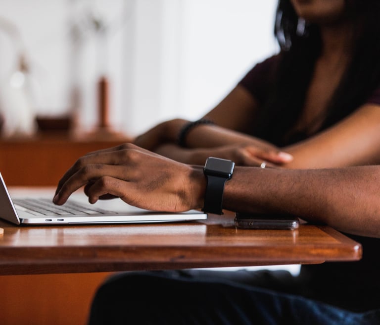 People in tech at a laptop