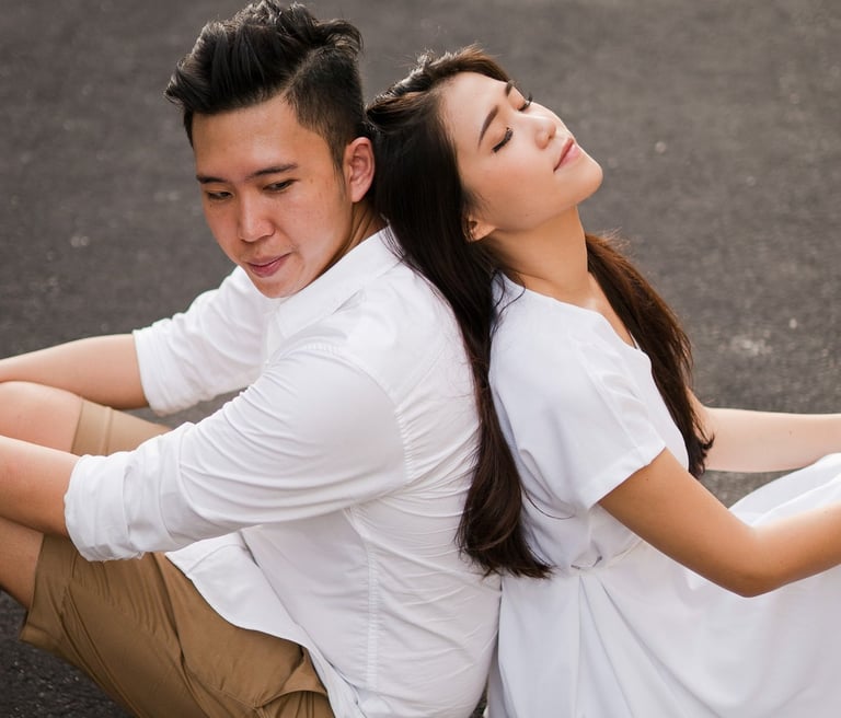 Couple sitting together in a romantic moment during proposal photoshoot at Melasti Beach Bali