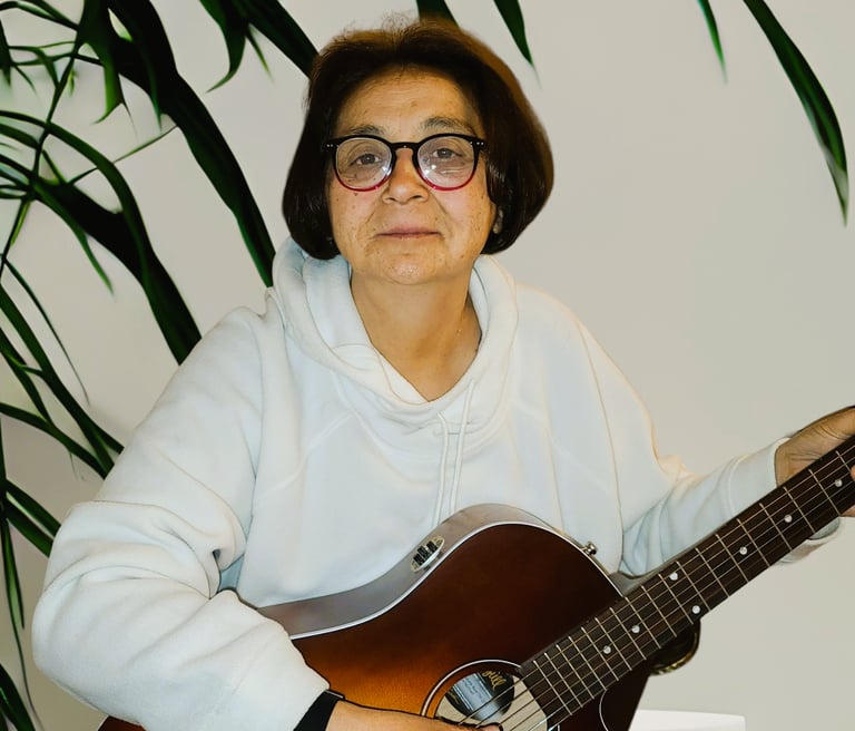 Diane Fischer holding a guitar