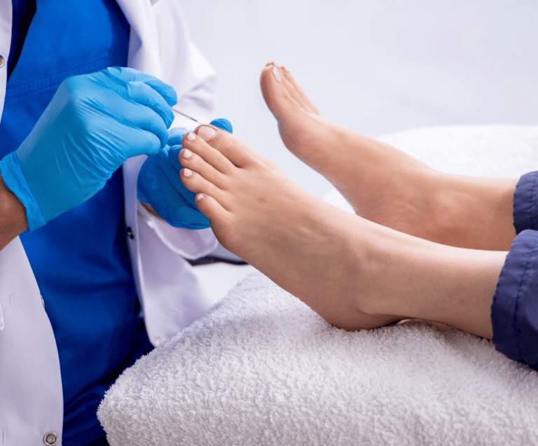 Foot Nurse with a patient's foot in home
