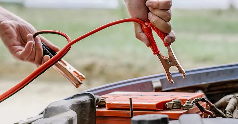 a person holding a jump rope connected to a battery