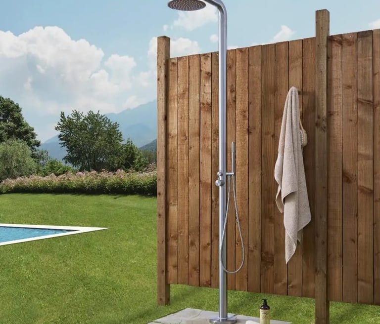 a shower with a shower head and a towel