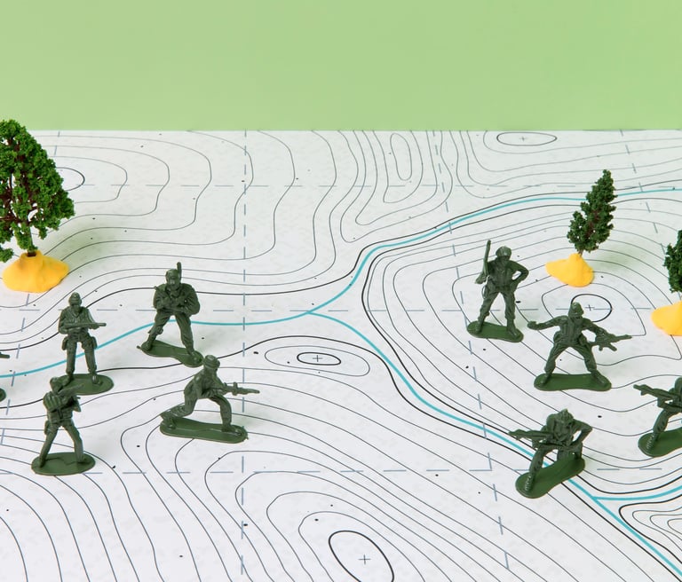 Group of plastic soldiers arranged on a topographic map, representing military strategy