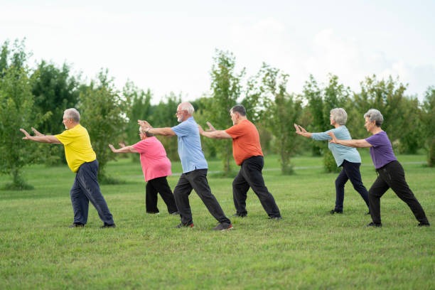 A group adults practicing Tai Chi outdoors for fun and wellness