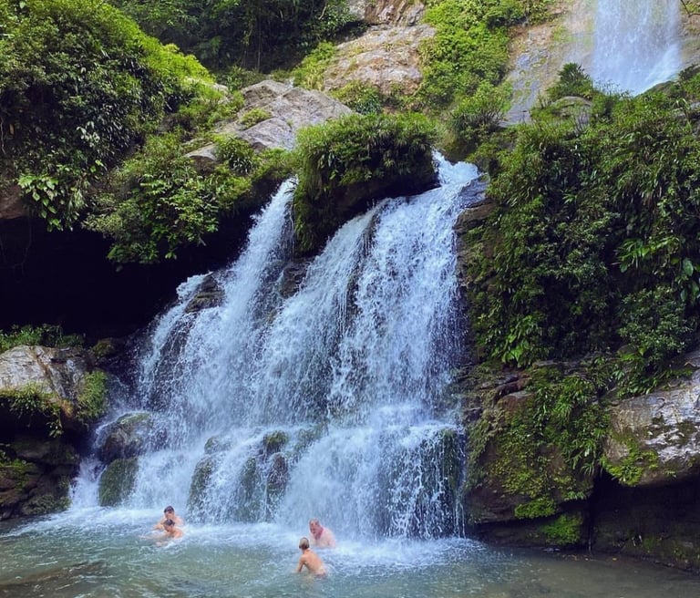 People swimming and enjoying a natural waterfall in Santa Fe, Veraguas, Panama.