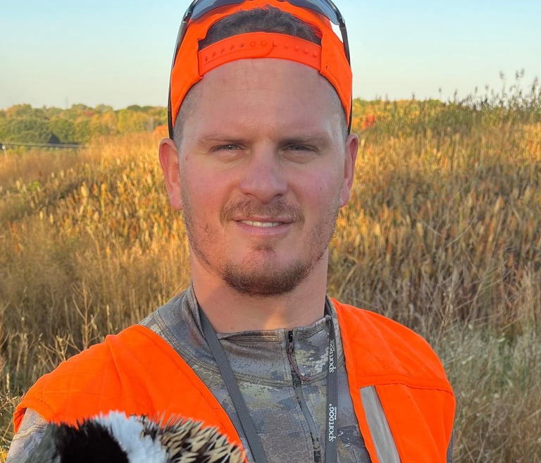 Boss Pressure Washing LLC owner Torsten Boss wearing blaze orange hunting gear outdoors