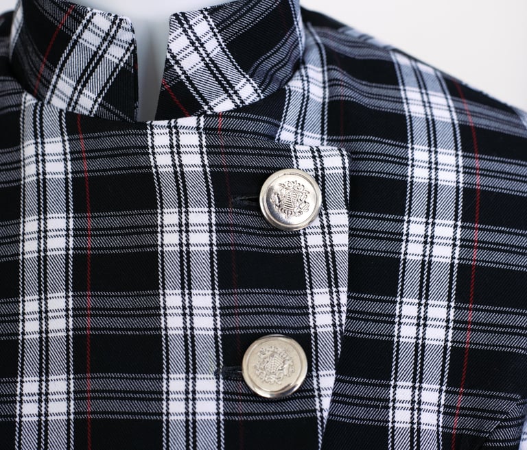 Details of Rogue Coat showing metal buttons and tartan details
