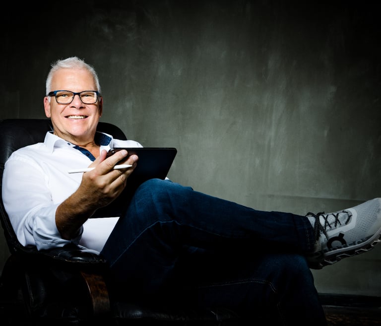 Martin sitting in a chair with a tablet