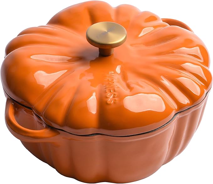Orange pumpkin shaped cast iron pot with a gold handle.