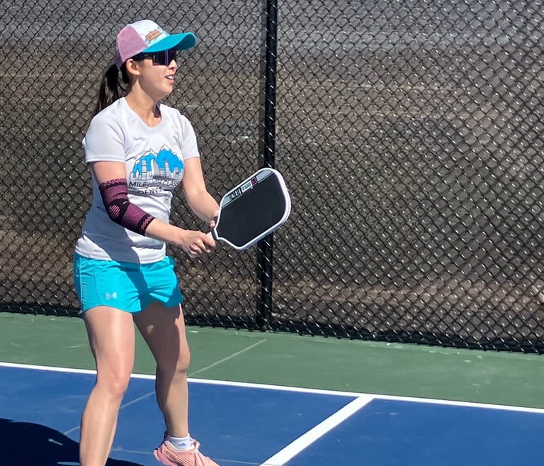 Ellen playing pickleball on an outdoor court, showcasing active Smart Dinker coaching in action.