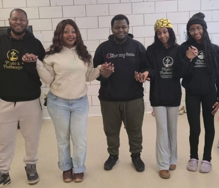 Plate & Pathways founder Alicia Spradley and her family volunteering at a food drive event