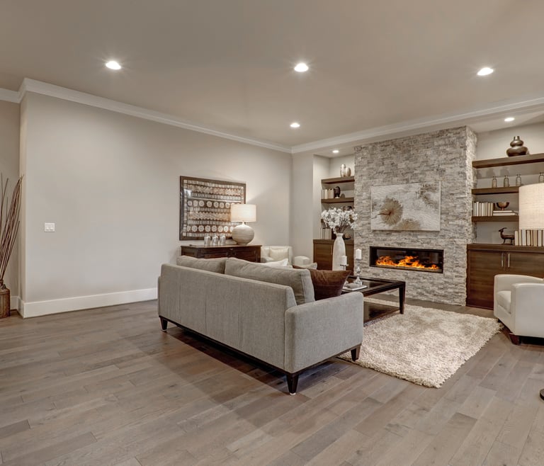 Newly finished basement with luxury vinyl flooring, recessed lighting and electric heat fireplace
