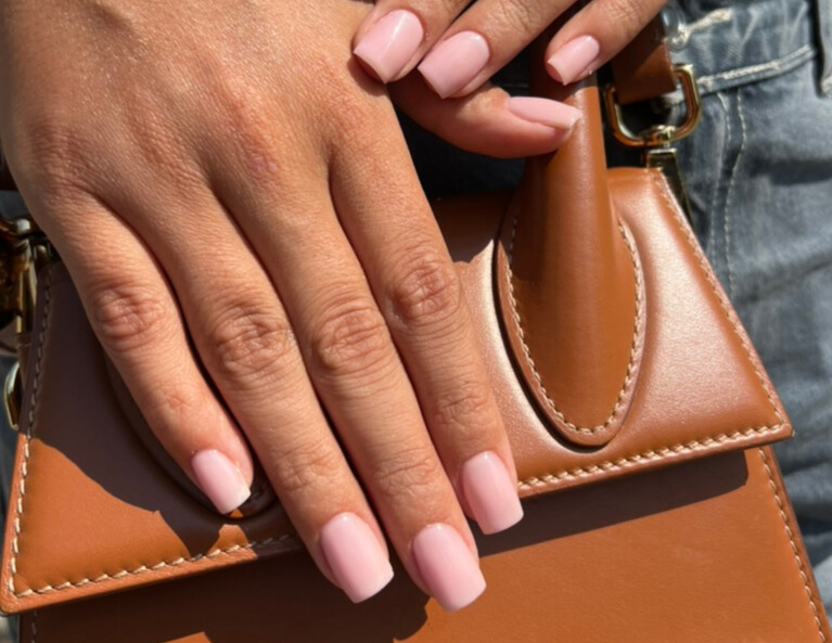 a woman's hand holding a purse and a purse