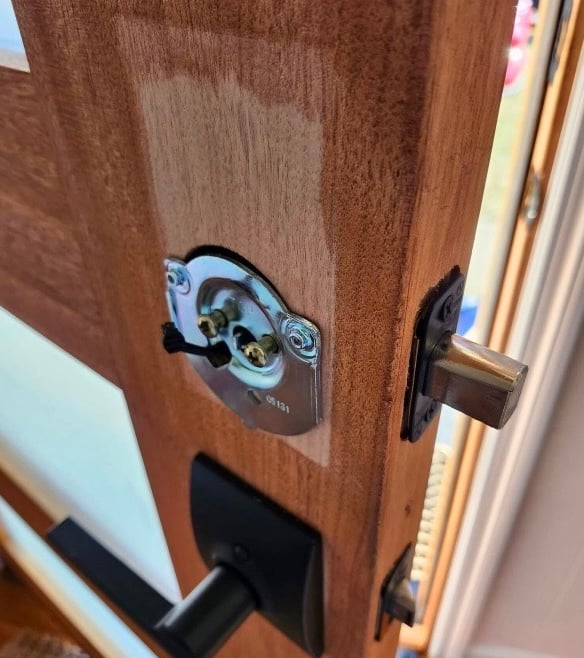 Wood door being repaired for residential locksmith door repair service in Boone, NC