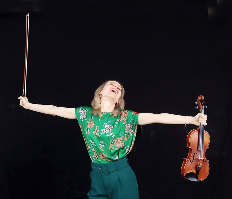 Houston violin teacher holding her violin