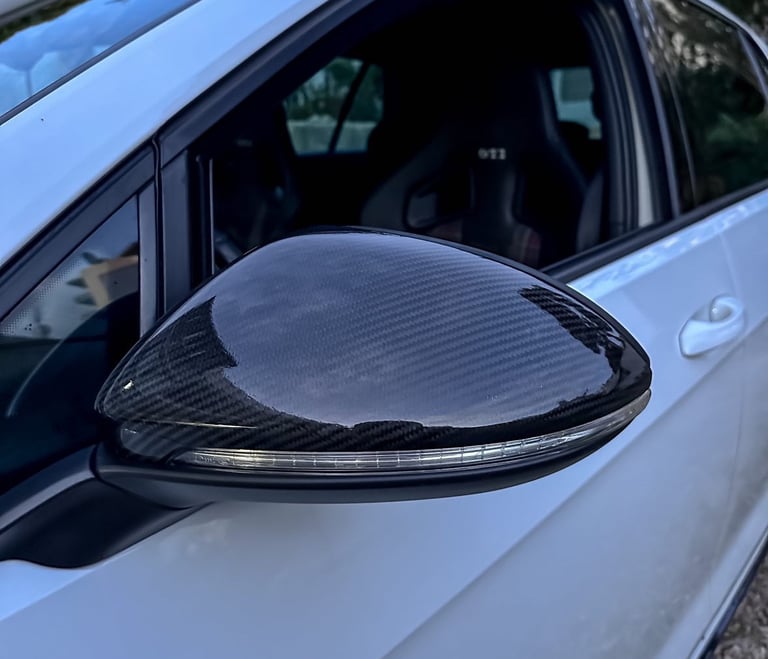a car with a black and white car door mirror