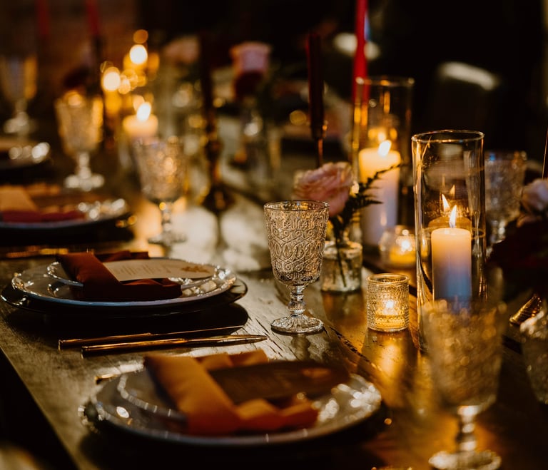 tablescape at chapel and cellar in winter park moody romantic with candles roses black chargers