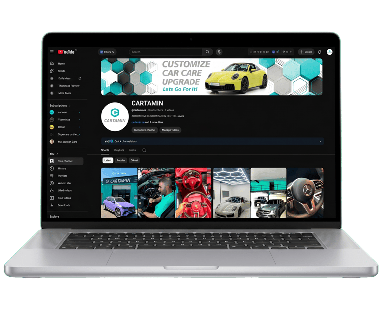 A laptop displaying the CARTAMIN YouTube channel focused on luxury car care and customization upgrades.