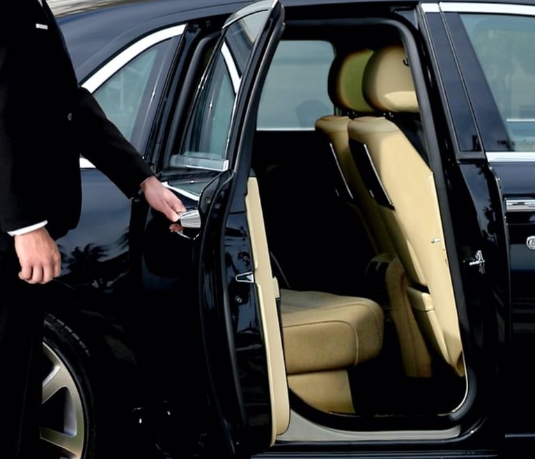 DOUBLE VIP chauffeur opens the door of a luxury for professional limousine service.
