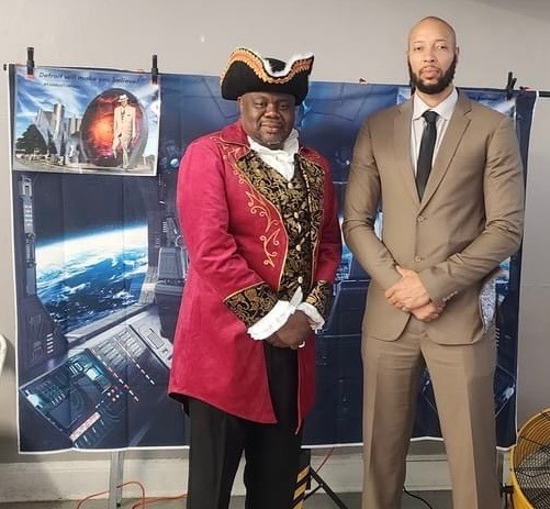 Braxton Vanzant, as Marcus Garvey Heru, poses with Rashad Singleton, National Reparations League