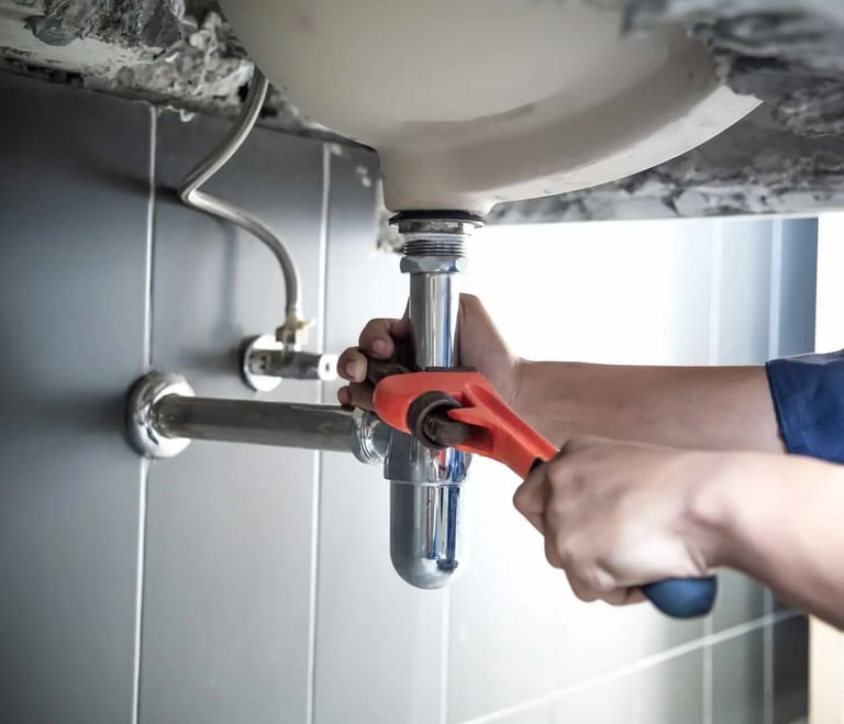 Suasana Plumbing services repairing sink u-trap, pipes, and water leaks.