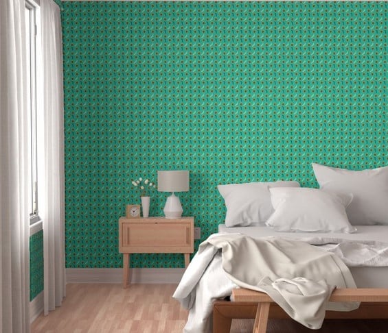 a bedroom with a bed and green wallpaper