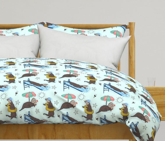 a bed with a bed sea otters