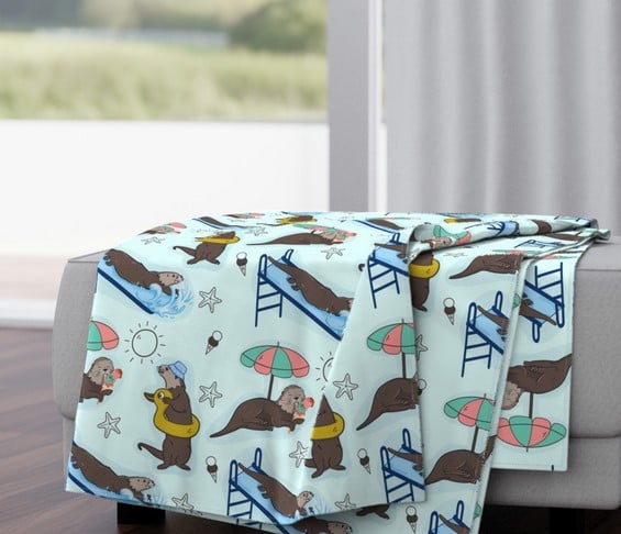 a couch with a sea otters blanket on it