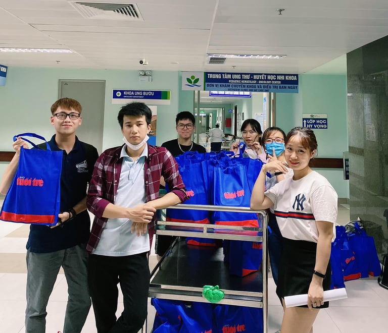 a group of people standing around a carton