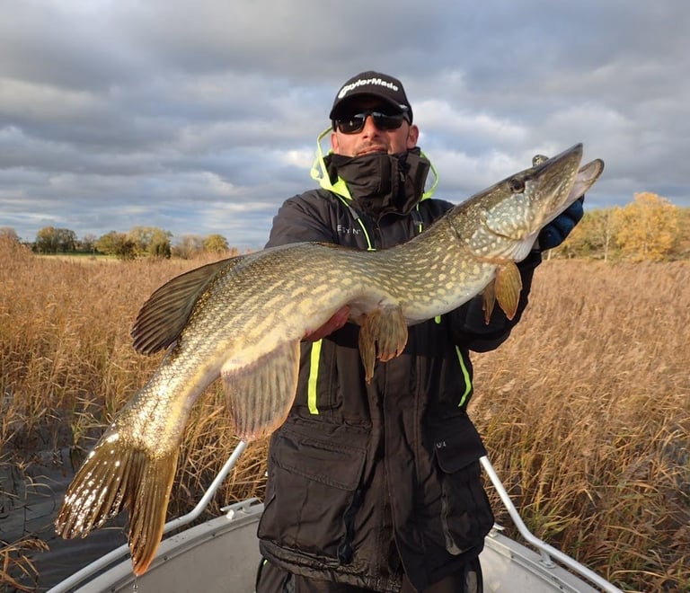 angler holding a pike 