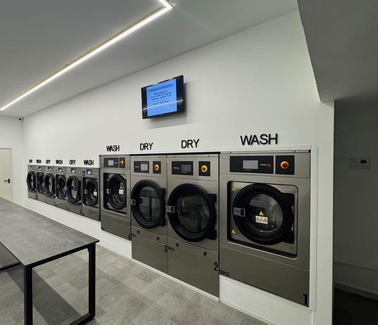 a row of washing machines in a laundry room