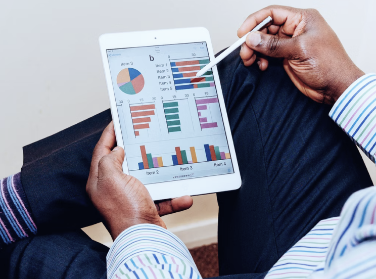 a man inspecting a tablet containing metrics