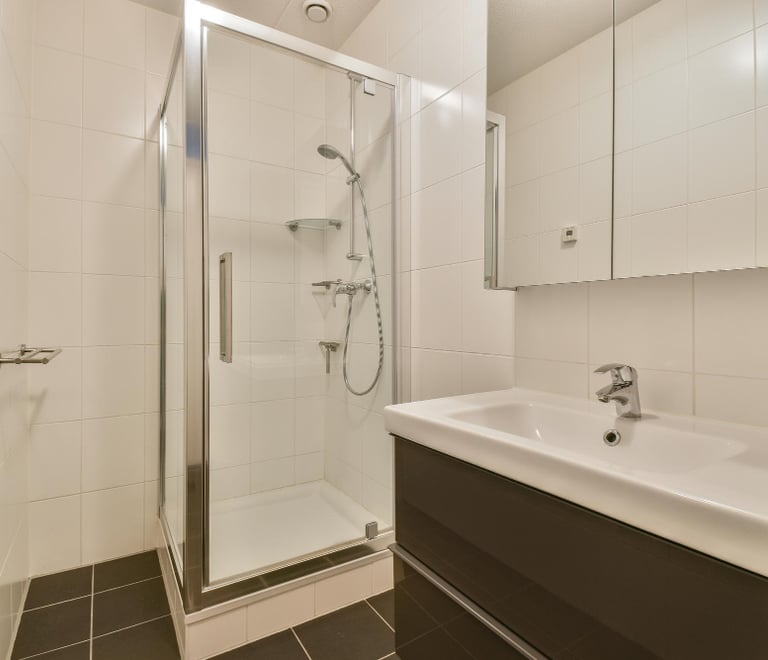 Small bathroom with square shower tray and basin