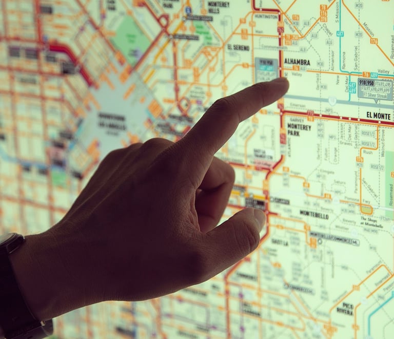 a person pointing at a map of a map of a map of a city