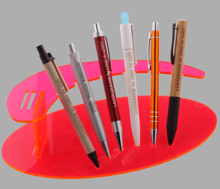 a pen and a pen on a red tray