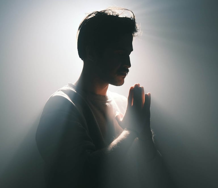 a man in a suit and tie is praying