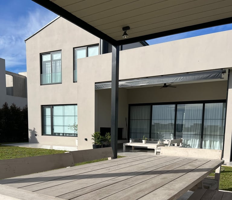 a table with a table and chairs in front of a house