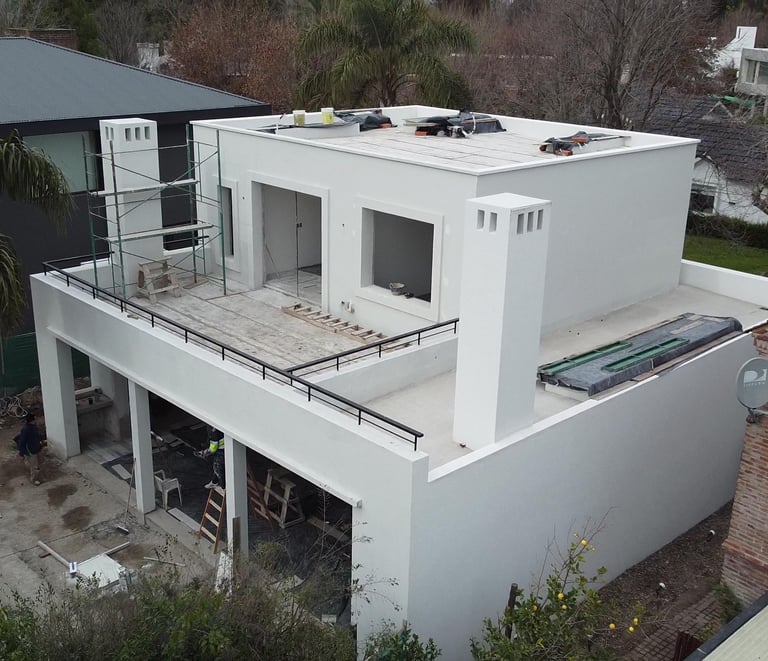 a house with a roof that has a balcony and a balcony
