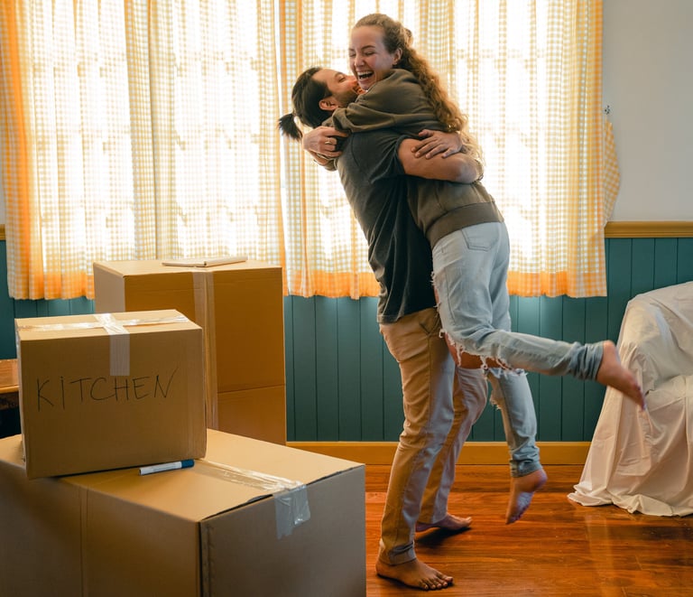 a man and woman are hugging in a room