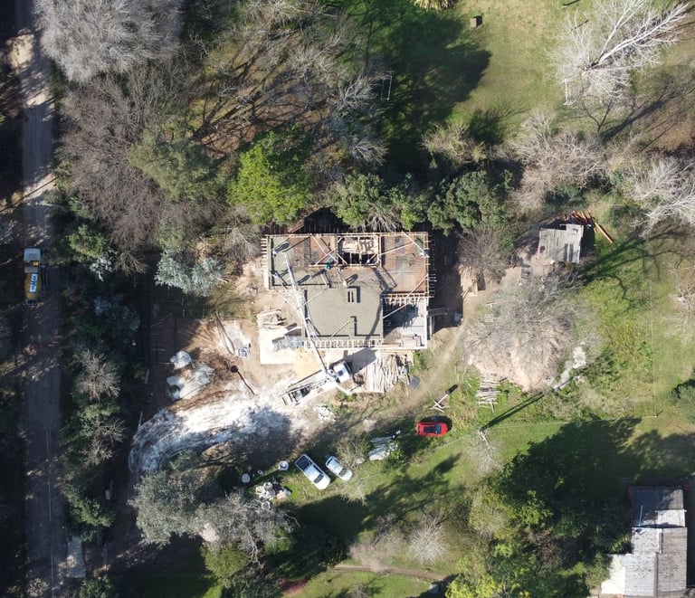 a house with a large house in the middle of a yard
