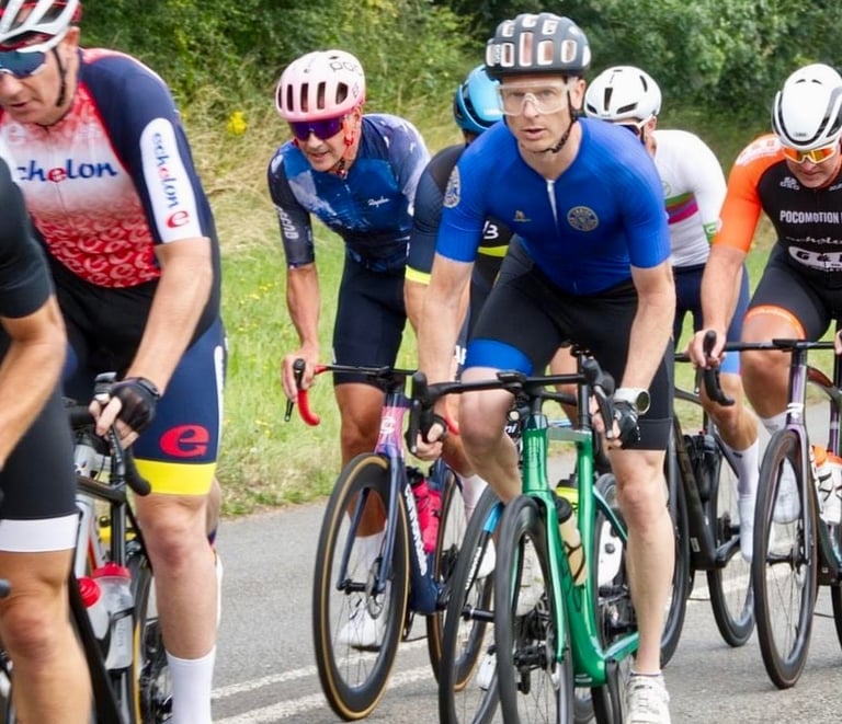 a group of cyclists mid race on a road